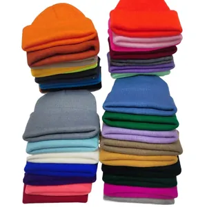 Multiple rows of colorful solid knit beanies in various candy colors for winter.