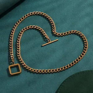 Close-up detail of a gold-plated titanium steel Cuban chain necklace with minimalist OT toggle clasp.