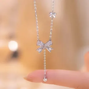 Detailed macro view of an S925 silver bowknot pendant necklace with sparkling cubic zirconia