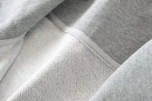 Detail shot of high-quality grey french terry fabric and stitching on cotton sweatshirt