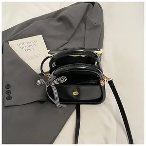 Minimalist black glossy crossbody bag for women with checkered ribbon and lace detail