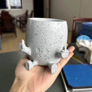 Detail shot of funny resin middle finger planter with speckled finish