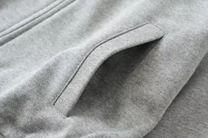 Detailed macro view of gray fleece fabric texture and pocket on vintage zip-up sweatshirt
