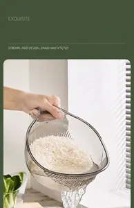 Macro view of a grey transparent rice washing bowl draining water in a bright kitchen