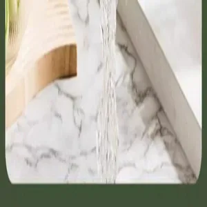 Close-up of water flowing through a white kitchen rice washing and draining basket