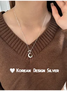 Detailed macro view of S925 sterling silver moon necklace with OT clasp on female model