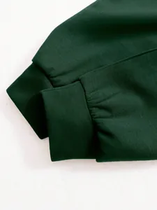 Detailed macro shot of dark green ribbed elastic cuffs on a women's leisure sports jacket
