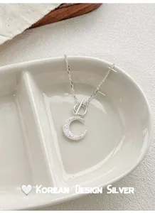 Detail view of S925 sterling silver moon pendant necklace with frosted finish and OT clasp