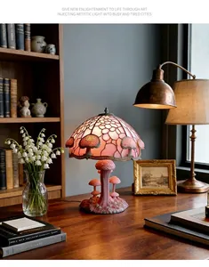 Detailed view of an ornate pink resin mushroom lamp placed on a vintage wooden desk