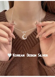 Detailed view of an elegant S925 sterling silver moon pendant necklace with OT clasp.