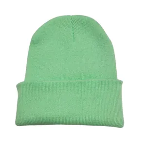 Soft mint green knitted beanie hat with classic folded cuff for winter warmth.