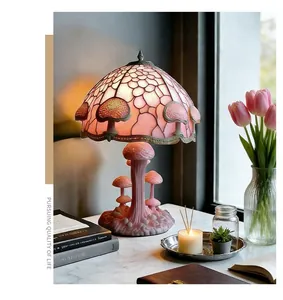 Detailed view of a pink Tiffany-style mushroom lamp on a cozy marble desk