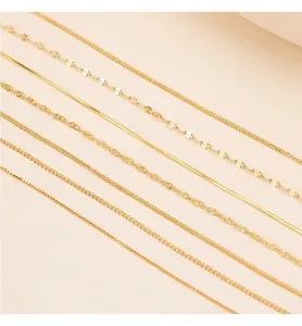 Macro view of seven diverse gold-finished necklace chains including snake and box links