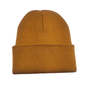 Detailed close-up of a mustard yellow winter knitted beanie with soft ribbed texture