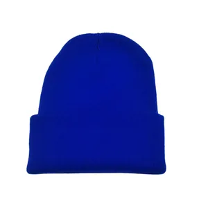 Close-up detail of a vibrant royal blue solid color knitted beanie for winter warmth