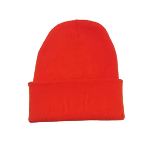 Detailed macro view of the vibrant orange knitted beanie hat showing thick winter yarn texture