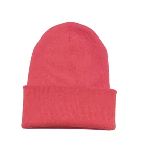 Close-up detailed view of the coral red ribbed knit beanie featuring a folded cuff