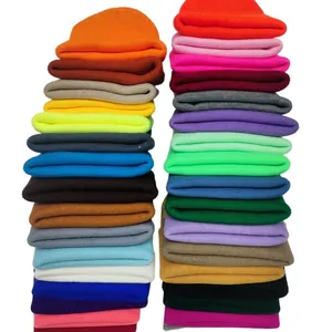 Vibrant solid color knit beanie hats stacked for cozy and warm winter style.