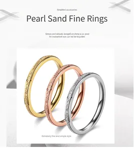 Detailed view of three minimalist frosted rings in gold, rose gold, and silver finishes
