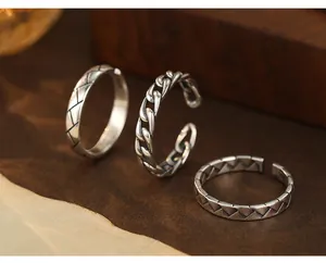 Detailed view of three vintage S925 Thai silver rings with unique woven and chain patterns