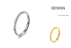 Detailed view of slim frosted titanium steel rings in elegant silver and gold