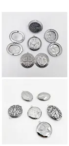 Detailed macro view of various engraved stainless steel locket pendants for DIY jewelry.