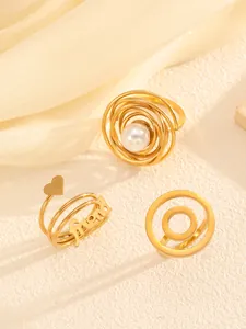 Close-up of three elegant gold titanium steel rings featuring pearl and friend details