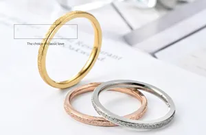 Detail view showing frosted texture of gold, rose gold and silver titanium steel rings.