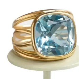 Elegant gold multi-strand band ring with a large square faceted light blue crystal stone