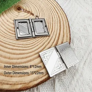 Detailed view of vintage book-style photo locket showing inner and outer dimensions.