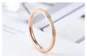 Detailed macro shot of a rose gold titanium steel ring with a frosted texture finish