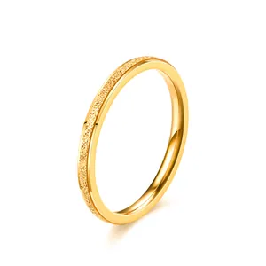 Close-up of a minimalist gold titanium steel ring with a frosted texture finish