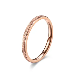 Detailed macro shot showing the fine frosted texture of a rose gold titanium steel ring