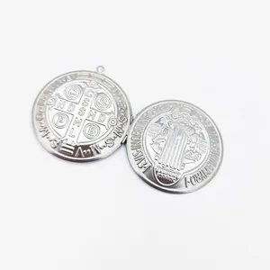 Close-up detail of a Saint Benedict medal engraved stainless steel photo locket