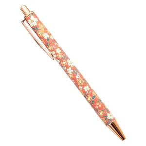 Elegant floral print retractable ballpoint pen with rose gold accents on white background