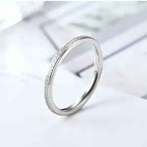 High-quality close-up of a minimalist titanium steel ring with a frosted surface texture