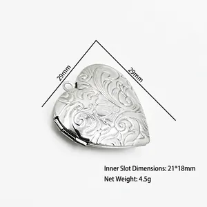 Detailed view of a silver heart locket with dimensions and vintage floral engraving