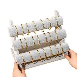 3-tier grey velvet jewelry display stand for bracelets and watches with gold bangles