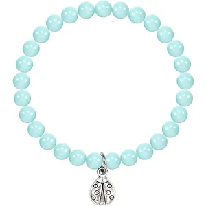 Close-up of a blue turquoise bead bracelet with a silver ladybug charm pendant