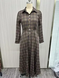 Elegant plaid maxi shirt dress featuring long sleeves and elastic waist on mannequin