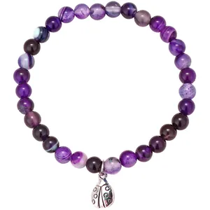 Detailed macro view of a natural purple agate beaded bracelet with ladybug charm
