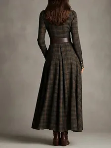 Elegant back view of long plaid maxi shirt dress with pleated skirt and wide belt