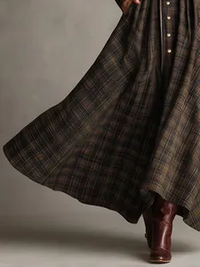 Detail view of the digital print plaid maxi dress with flowing pleated skirt texture