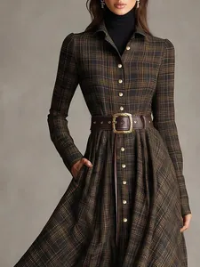 Detailed view of vintage plaid shirt dress featuring a brown leather belt with gold buckle