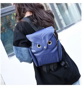 Detailed view of a stylish blue owl-shaped cartoon backpack for women in outdoor light