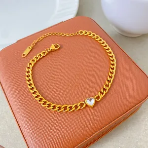 Detailed view of a titanium steel gold plated necklace with a clear heart zircon pendant.