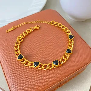 Detailed view of titanium steel gold-plated necklace with five black heart zircons