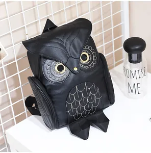 Close-up shot of a stylish black owl shaped backpack featuring golden eye details