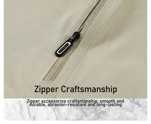 Macro view of high-quality black zipper hardware on a khaki quick-dry outdoor sports shirt