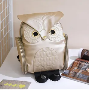 Detailed frontal view of a stylish golden owl-shaped cartoon backpack for women.
